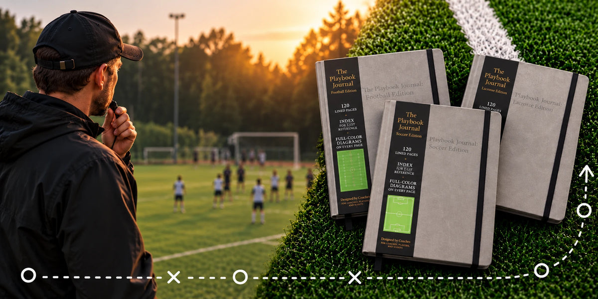 A coach in a black cap blows a whistle and watches players on a field at sunset, next to three Playbook Journal hardcover journals on turf.
